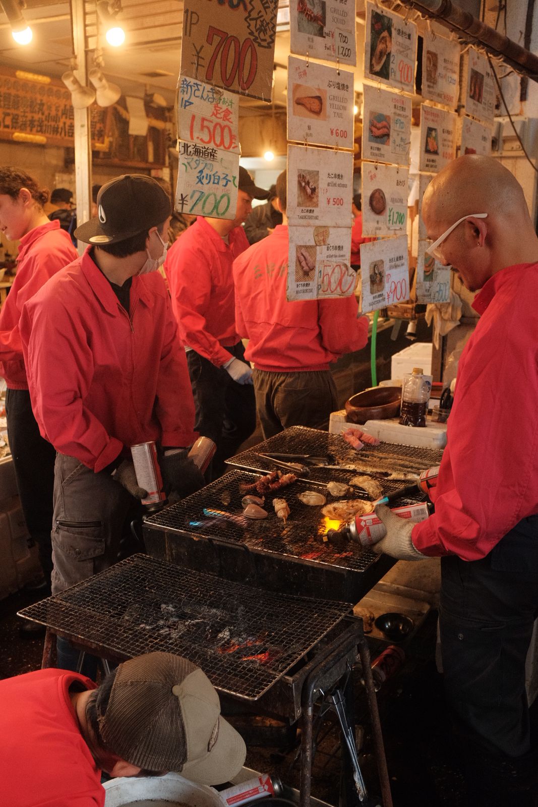 Grill cooks in red jackets at Tsukiji